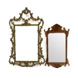 A gilt framed mirror of scrolling outline,