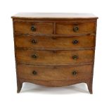 A mahogany bowfront chest of two short over three long drawers, on splayed feet,