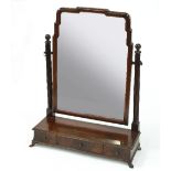 A mahogany swing mirror on a three-drawer box base,