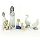 A group of six Lladro figures, two geese, Feeding the Lamb, Boy with a Dog,