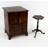 A mahogany commode with two panel doors above two graduated drawers and a mahogany tripod table,