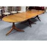 A mahogany extending dining table, the two D ends with tripod supports on brass caps and castors,
