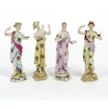 A pair of late 19th Century German porcelain figures, one with book,