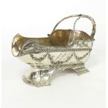 A French silver plated bottle carrier, of boat shape with scroll handle and foliate swag decoration,