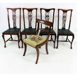 A set of four mahogany dining chairs with pierced splat backs,