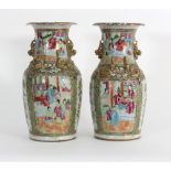 A pair of Cantonese vases painted alternating panels of flowers and figures in buildings,