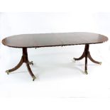 A mahogany two-pillar dining table,