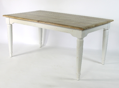 A pine kitchen table, the base painted white on turned and tapering legs,