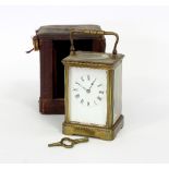 An eight-day carriage clock in a gilt brass case, with plain enamel dial and Roman numerals,