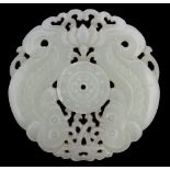 A Chinese white jade twin fish pendant, of circular form with pierced foliate decoration,