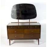 A mid 20th Century dressing table, mounted with a stylised mirror,