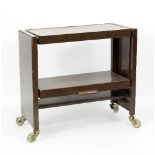 A 20th Century walnut metamorphic trolley/table, with concertina mechanism, on castors,