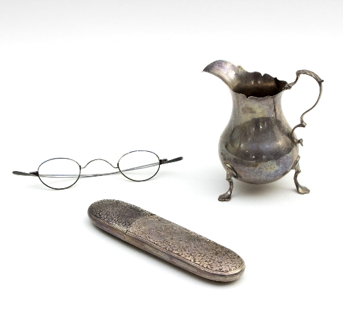 A George II silver cream jug, G S, London 1759, of pear shape on shaped feet,