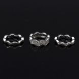 A set of three contemporary 18ct white gold rings, each of wavy form,