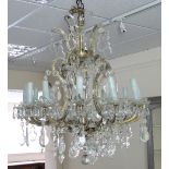 A twelve-light cut glass chandelier with scroll supports, rosettes and cut drops,