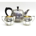 A silver three-piece tea set, A M, Birmingham 1948, of plain form with reeded stylised decoration,