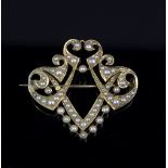 A Victorian half pearl set brooch of shield shape,