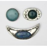 A Ruskin Arts and Crafts ceramic silver mounted brooch, of circular form stamped Ruskin,