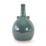 Russell Collins, Hook Norton Pottery/A mottled blue and green bottle vase with pierced lugs,