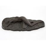 A 20th Century bronze of a sleeping nude, facing down on a naturalistically modelled rocky base,