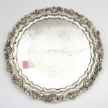 A Victorian plated salver with shell and C scroll border,