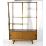 A mid 20th Century teak display cabinet with an arrangement of open shelves above two sliding doors,