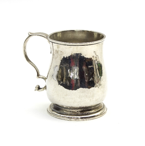 A George II silver mug, Richard Gurney & Thomas Cook, London 1754, ogee shaped on a skirt base,