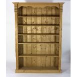 A modern pine bookcase with shaped frieze, fitted five shelves,