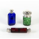 A double-ended red glass scent bottle, with engraved white metal covers,
