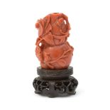 A Chinese carved hardstone snuff bottle of double gourd form, on a small carved wood stand,