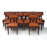 A set of eleven mahogany dining chairs, each with reeded column back supports, sides and sabre legs,