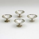 A set of four Chinese white metal footed bowls of circular shape with dimpled finish,