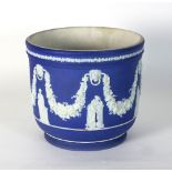 A Wedgwood Jasperware jardinière decorated classical figures with floral swags to a blue ground,