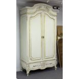 A French painted armoire, the arched pediment above panelled doors,
