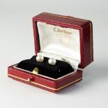 A pair of natural saltwater pearl stud cufflinks by Cartier, set in 14k gold,