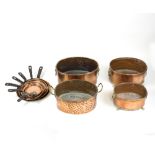 A set of eight graduated copper pan covers and four copper oval jardinières