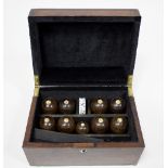 A mid 19th Century indoor bowls set in a mahogany case with parquetry cover,
