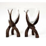 A pair of faux antler centrepieces, each supporting a clear glass bowl,