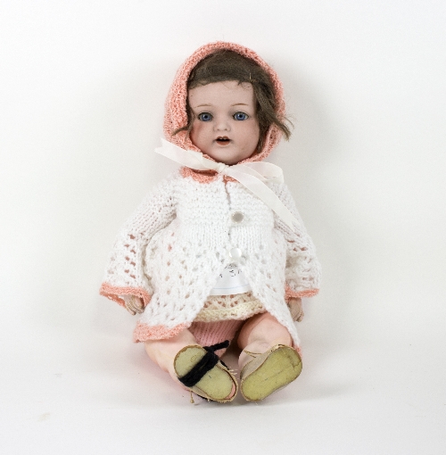 An Armand Marseille bisque head doll with sleeping eyes, open mouth and jointed composite body,