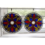 A pair of Edwardian circular stained glass leaded lights with acanthus decoration,