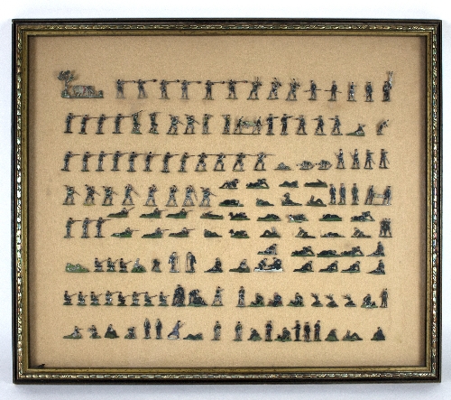 A large quantity of flat tin soldiers mounted on boards, framed and glazed,