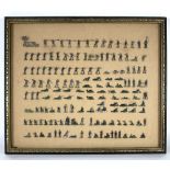 A large quantity of flat tin soldiers mounted on boards, framed and glazed,