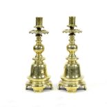 A pair of brass Dutch style candlesticks,