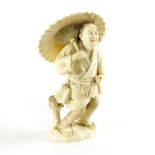 A Japanese carved ivory okimono, Meiji period, signed, depicting a man with umbrella (damages), 15.