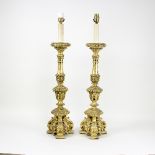 A pair of Italian style giltwood table lamps on tripod bases,