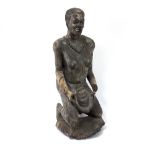 A carved African figure of a kneeling woman,