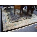 A Chinese silk carpet, the central floral medallion to a trellis ground within a floral border,