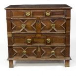A 17th Century oak chest of four panelled drawers, in two sections, 92.