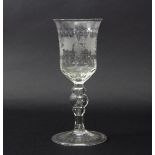 A glass goblet, circa 1760, engraved with vines on a hollow baluster stem and folded foot, 21.