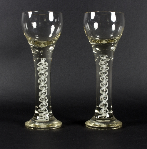 Two 20th Century oversized wine glasses, with opaque twist stems,